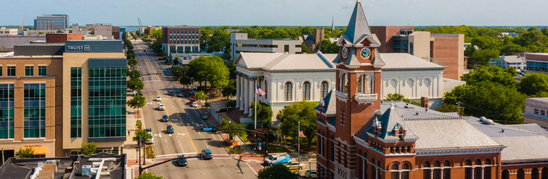 Aerial of cars driving in downtown Wilmington on a sunny day.