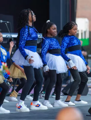 An all-girl dance troupe performs on stage at the Azalea Festival.