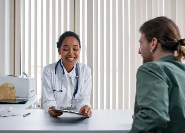 Doctor speaking with patient in office.