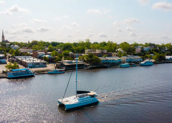 Overview of catamaran sailing on the Cape Fear River by downtown Wilmington.