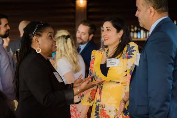 Three chamber of commerce members speak at a networking event.