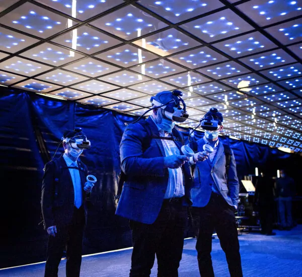Three professionals use GE Hitachi Nuclear Energy's virtual reality technology.