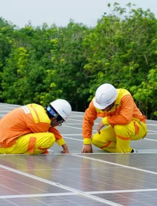 Two men work on a solar panel