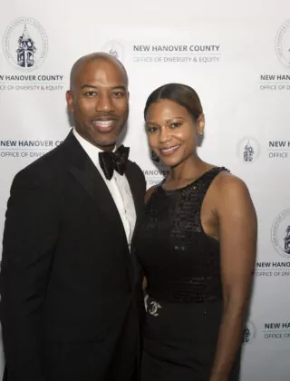 Two people pose at black tie event for diversity and inclusion.