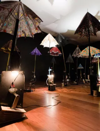 Underview of a group of umbrellas at an art exhibit at the Cameron Art Museum.