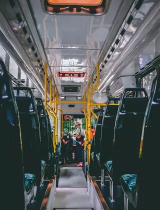 Woman standing in public bus.