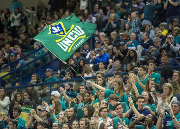 Crowd of students cheer on UNC Wilmington's basketball team.