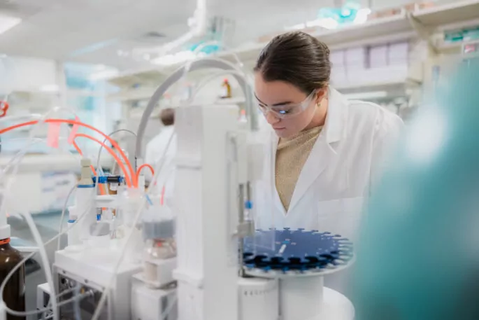 Female pharmaceutical scientist working in a lab.